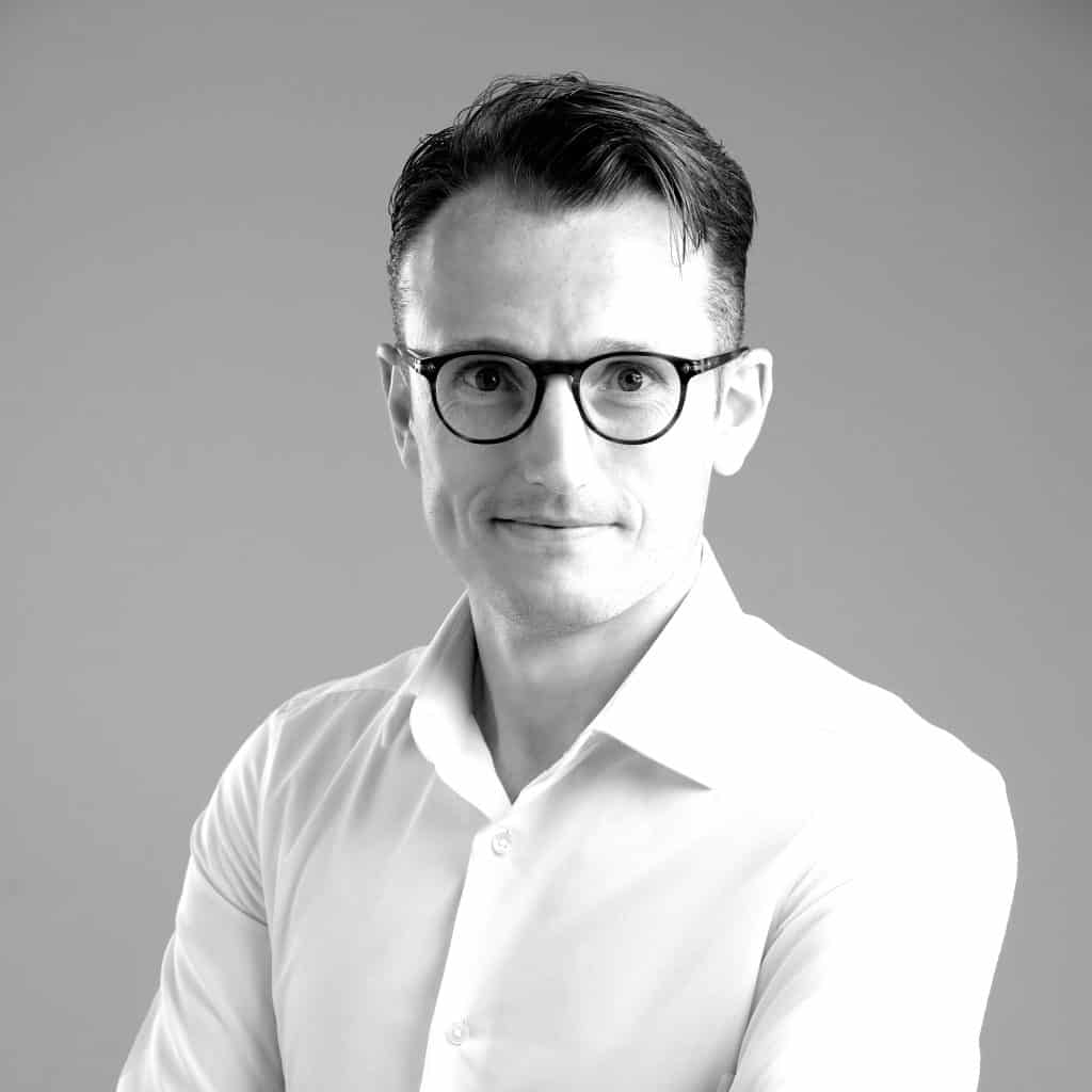 A black and white headshot of Christian, an employee in the Vital Consular Dubai office. He's an expert on moving to Dubai from UK, having done it himself!