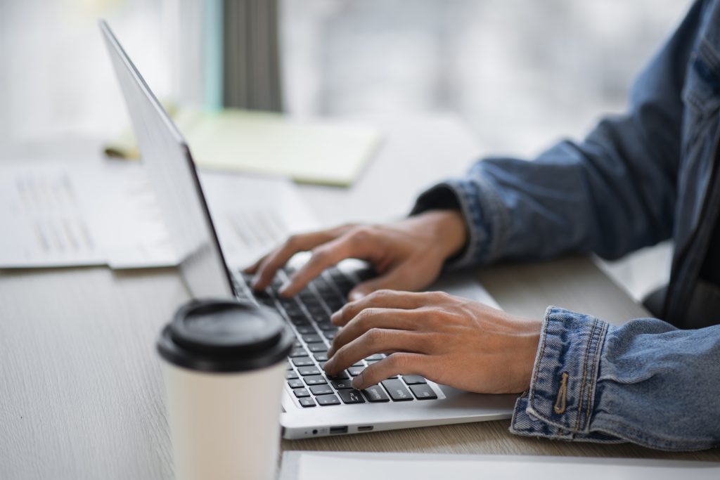 side view employee working laptop