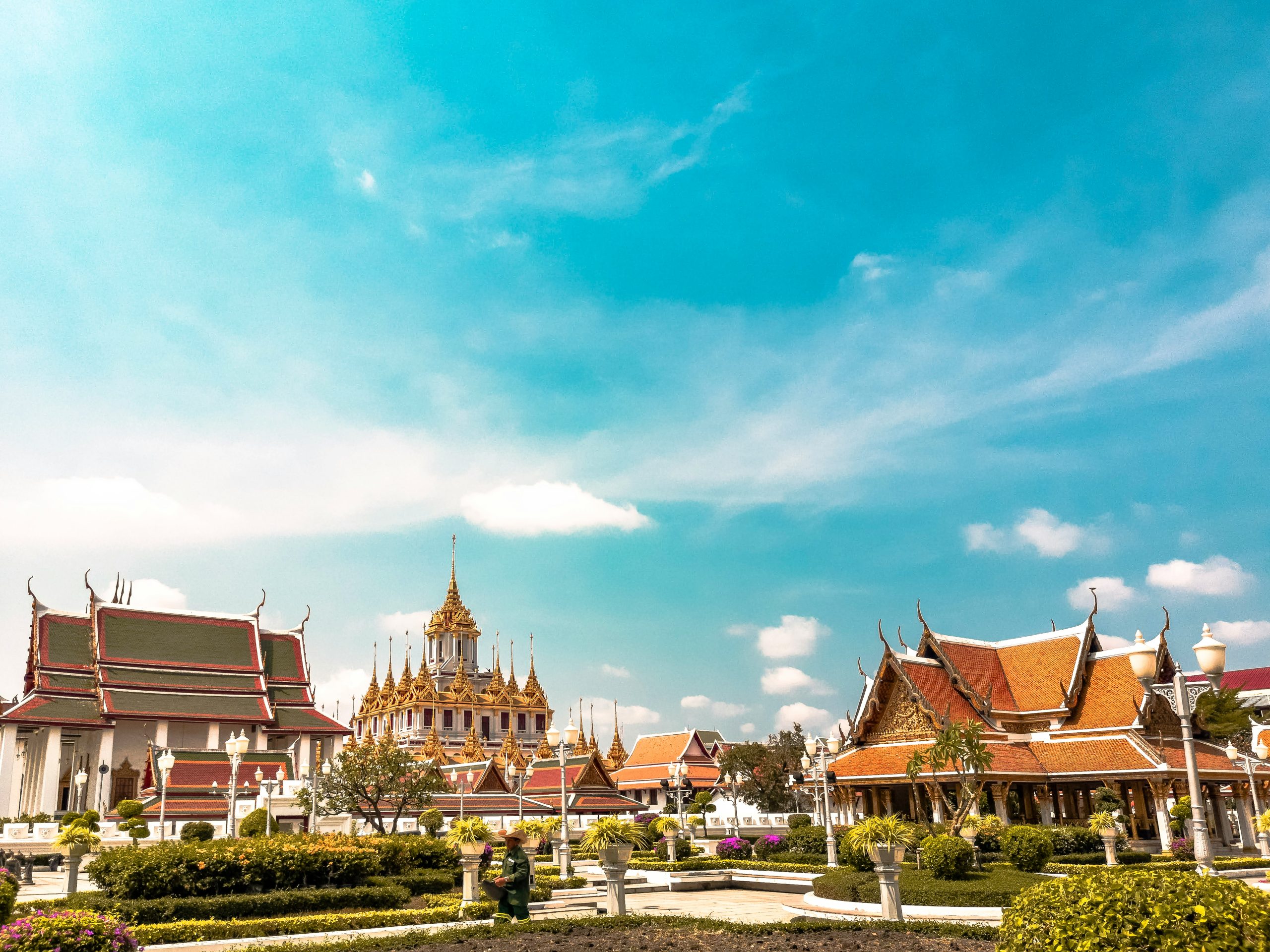 An image of orange temples in Loha Prasat, Thailand.